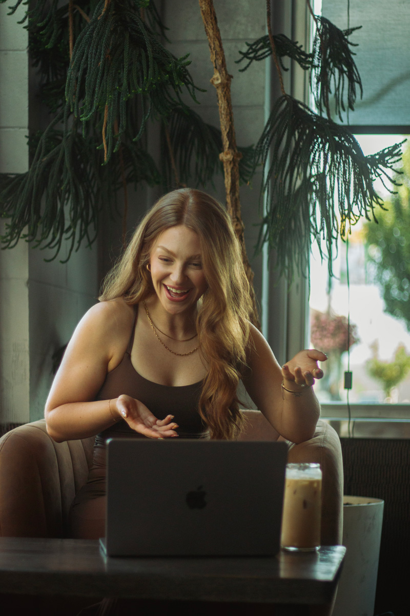 The coach is smiling while seeing the laptop